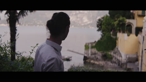 person walking by the lakeside garden
