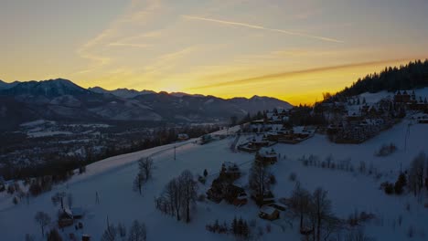 Frozen-Pine-Forest-duing-golden-hour-with-bright-yellow-skiy---Drone-Aerial-Butorowy-Wierch-Zakopane