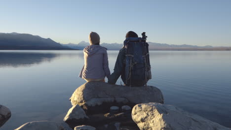 travelers at the lake pukaki viewpoint in mount cook, new zealand