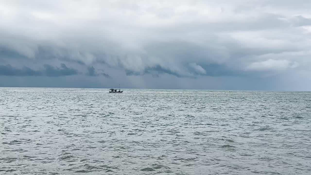Boat on stormy sea in Brasil, dramatic skies, sense of adventure