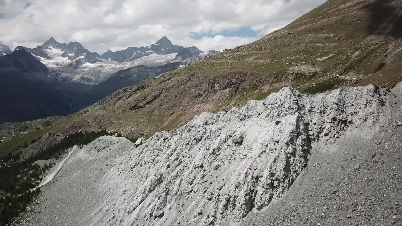 Swiss alps drone aerial view. rocky mountains and fields