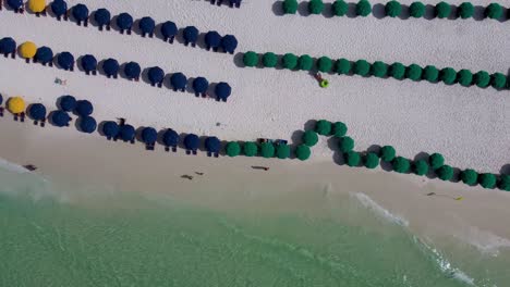 Destin-Florida-beach-service-chairs-on-the-beach-with-Gulf-of-mexico-turquoise-green-water,-Key-west-miami-Florida-Aerial-view-of-resort-hotel-chair-umbrella-beach-service-at-luxurious-hotel-resort-FL