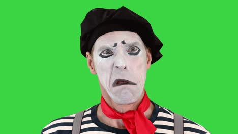 mime doing different emotions from smiling to being sad on a green screen, chroma key
