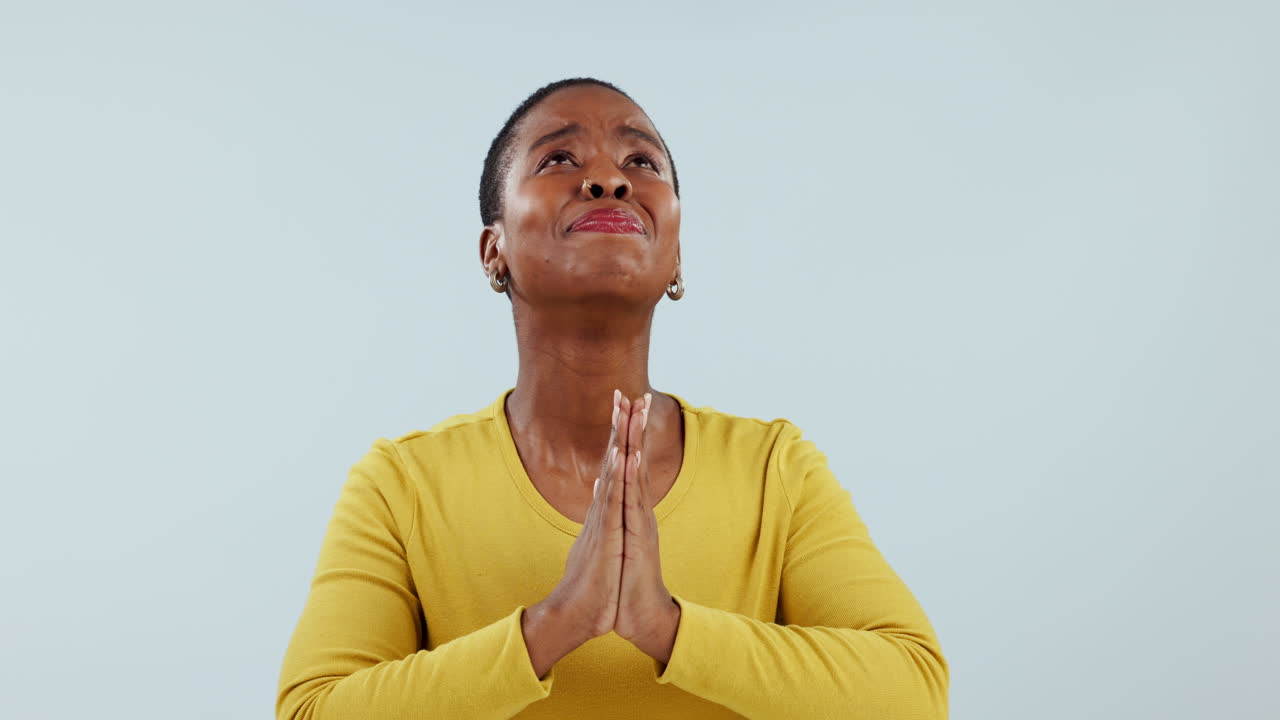 Hands, praying and black woman looking up