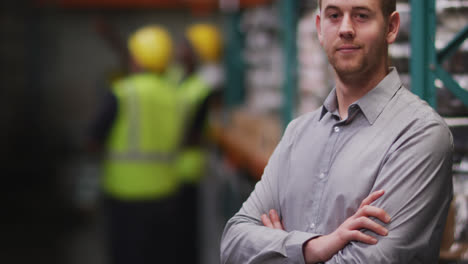 Caucasian-male-factory-worker-at-a-factory-looking-and-smiling-to-the-camera