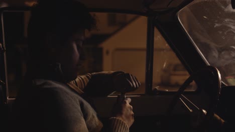 close up of teen driver drinking in vintage car while pulled over by police at night in 4k