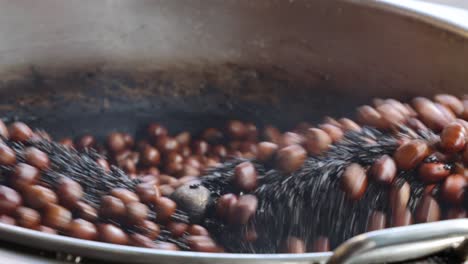 coffee beans being stirred and roasted evenly