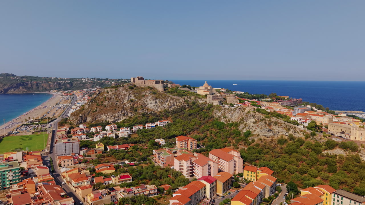 Colorful Sicilian coastal town in summer with vibrant buildings and beach