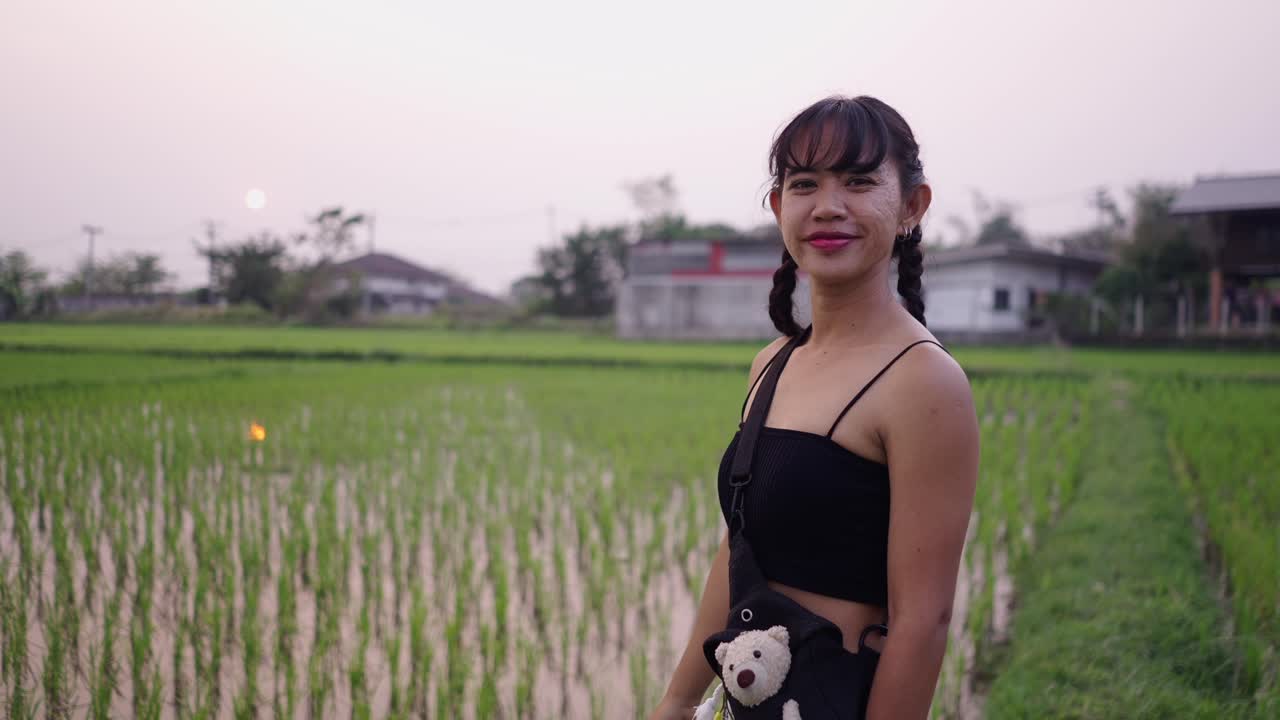 Woman in a rice field at sunset