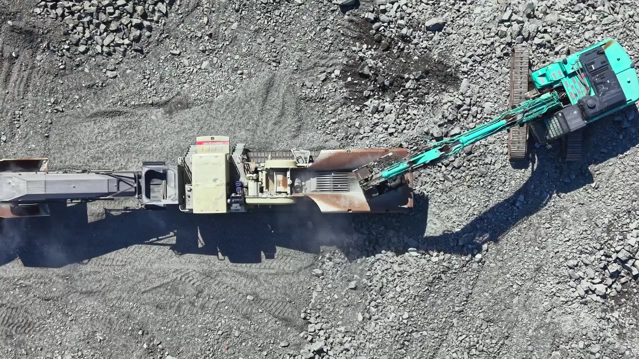 Granite quarry operation with heavy machinery at work