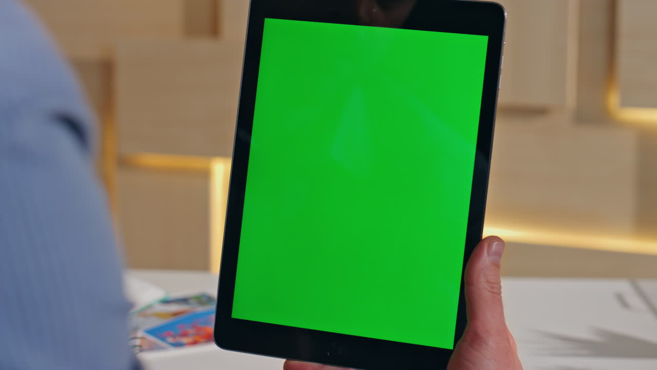 Man finger tapping chromakey tablet making online order at workplace close up.