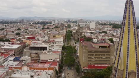 drone view, south to north of the fray antonio alcalde avenue and the metropolitan cathedral in downtown guadalajara, jalisco, mexico.