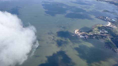 passenger pov from aircraft flying over the coastline near montevideo uruguay