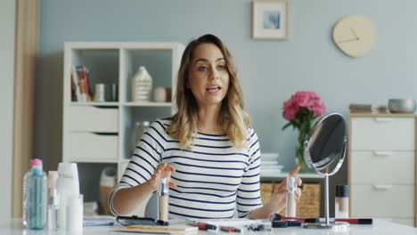 pretty beauty blogger recording a makeup tutorial video and talking about the best foundation 1