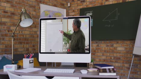 Mixed-race-male-teacher-on-computer-screen-during-video-call