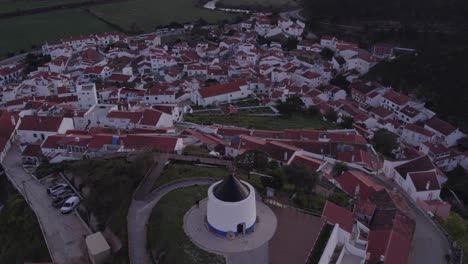 Flying-forward-over-Odeceixe-windmill-during-sunrise,-aerial