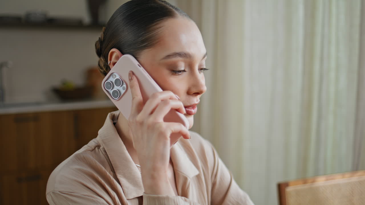 Calm girl communicating mobile phone sitting kitchen closeup. Brunette talking