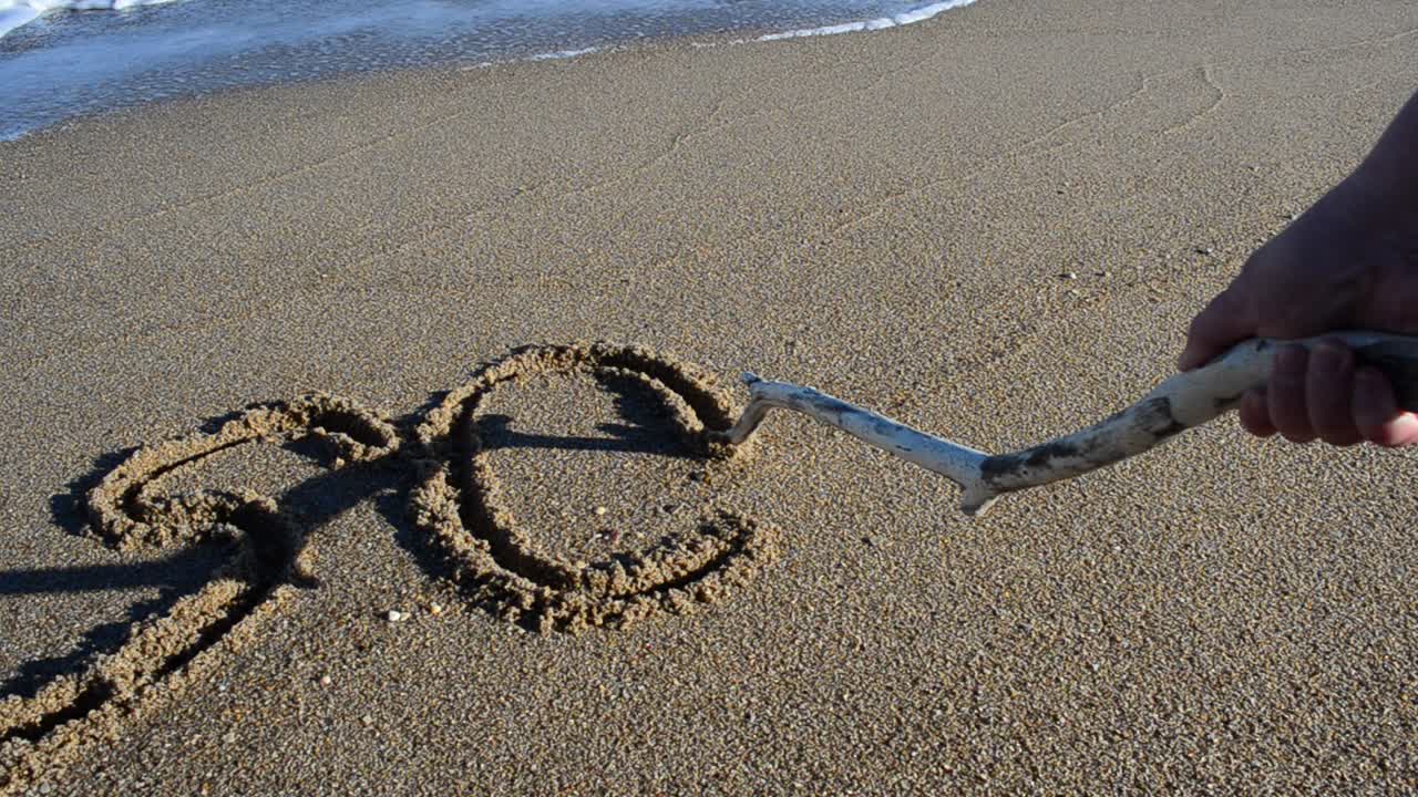 The word the sos on sand. Beach. Shooting on the beach