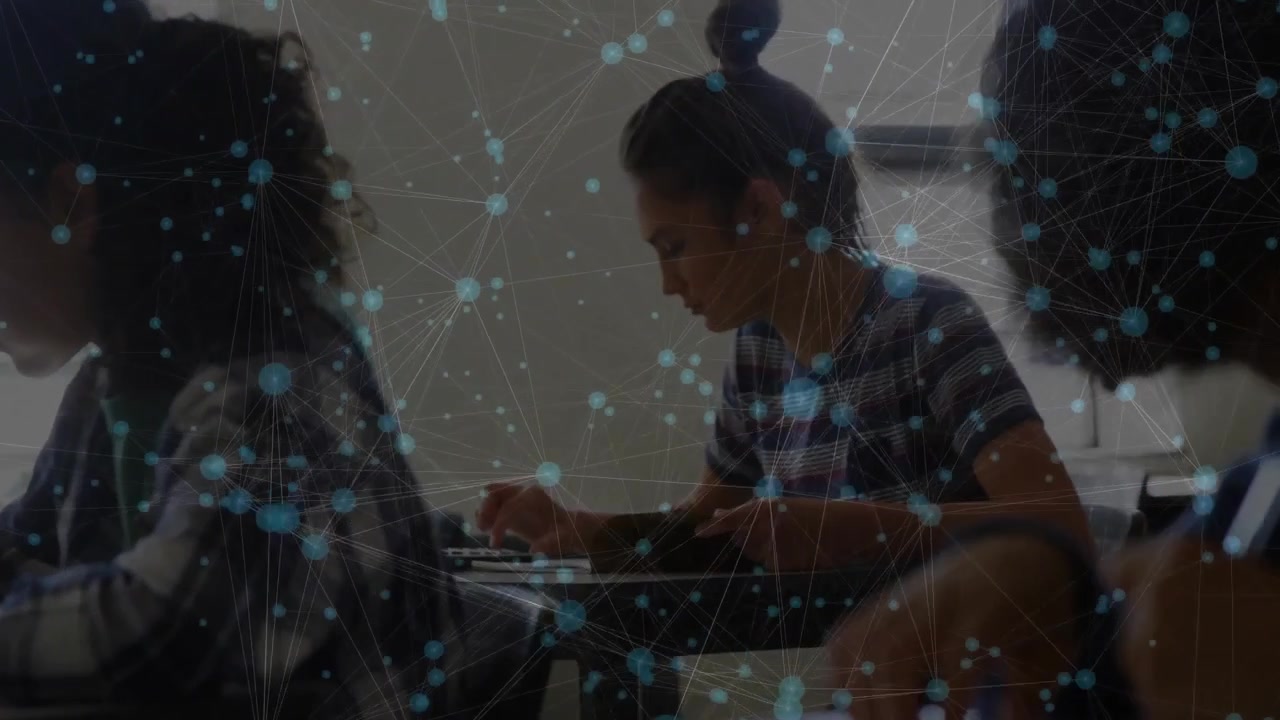 Camera initiating pan across students writing with network overlay showing education connectivity