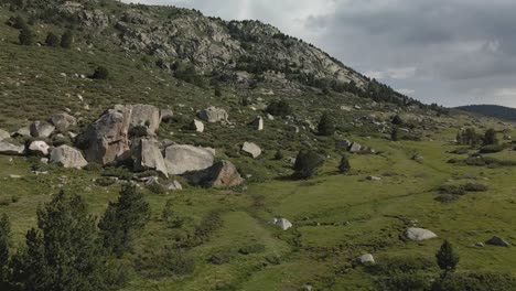 Aerial-view-of-the-mountains-and-fields-before-you-arrive-to-the-lake-Bulloses,-in-La-Cerdanya,-Catalunya