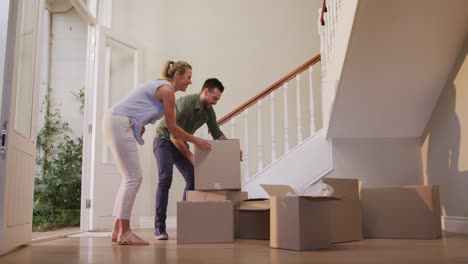 Caucasian-attractive-couple-moving-into-new-house