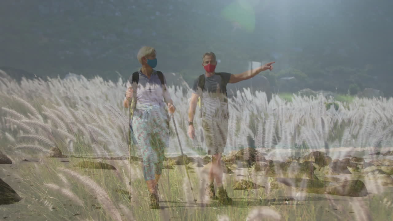 hiking couple walking shore wearing masks backpacks trekking poles showing animated health chart