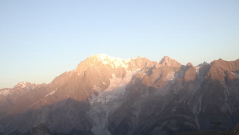 timelapse panoramic view of mont blanc mountain in alps at sunrise, sunlight on snow topped summit