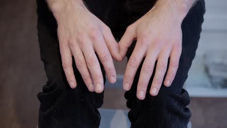 stressed man with shaking and restless hands, close up