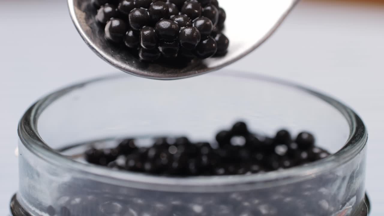 Caviar on a Spoon over a Jar
