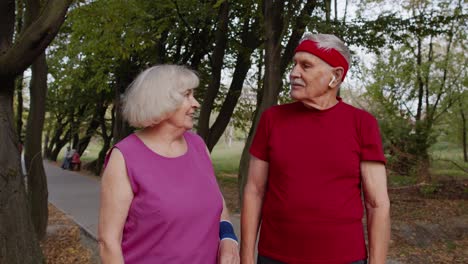 mature family couple together after running using smart watch, tracking result of fitness workout