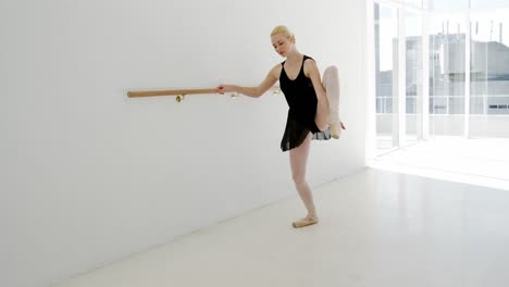 Ballerina-practicing-ballet-dance-at-barre