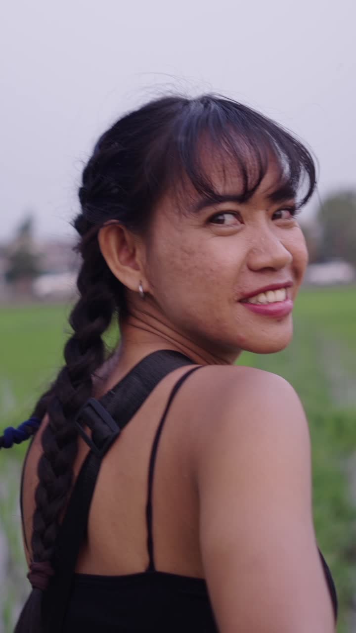 Woman holding hands in a rice paddy