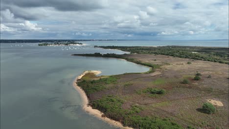 Dramatic-aerial-view-of-Studland-over-to-Sandbanks,-Dorset,-England