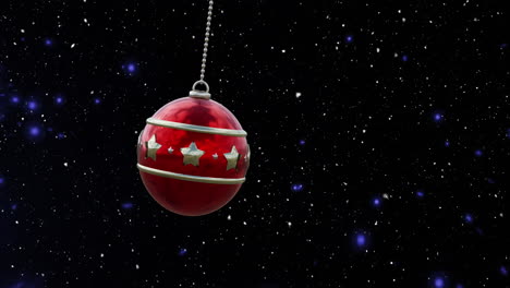 animation of christmas red bauble and snow falling on blue background