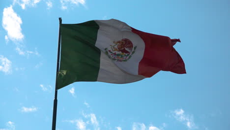 mexican flag waving in a blue sky