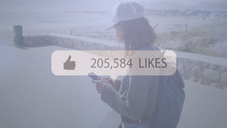 using phone with animation of social media likes, person with backpack