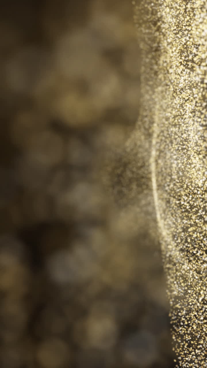 Gold glitter dust texture. Gold Particles. Luxury Design. Loop animation. Vertical video.