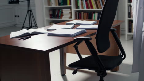 empty office desk with books and documents