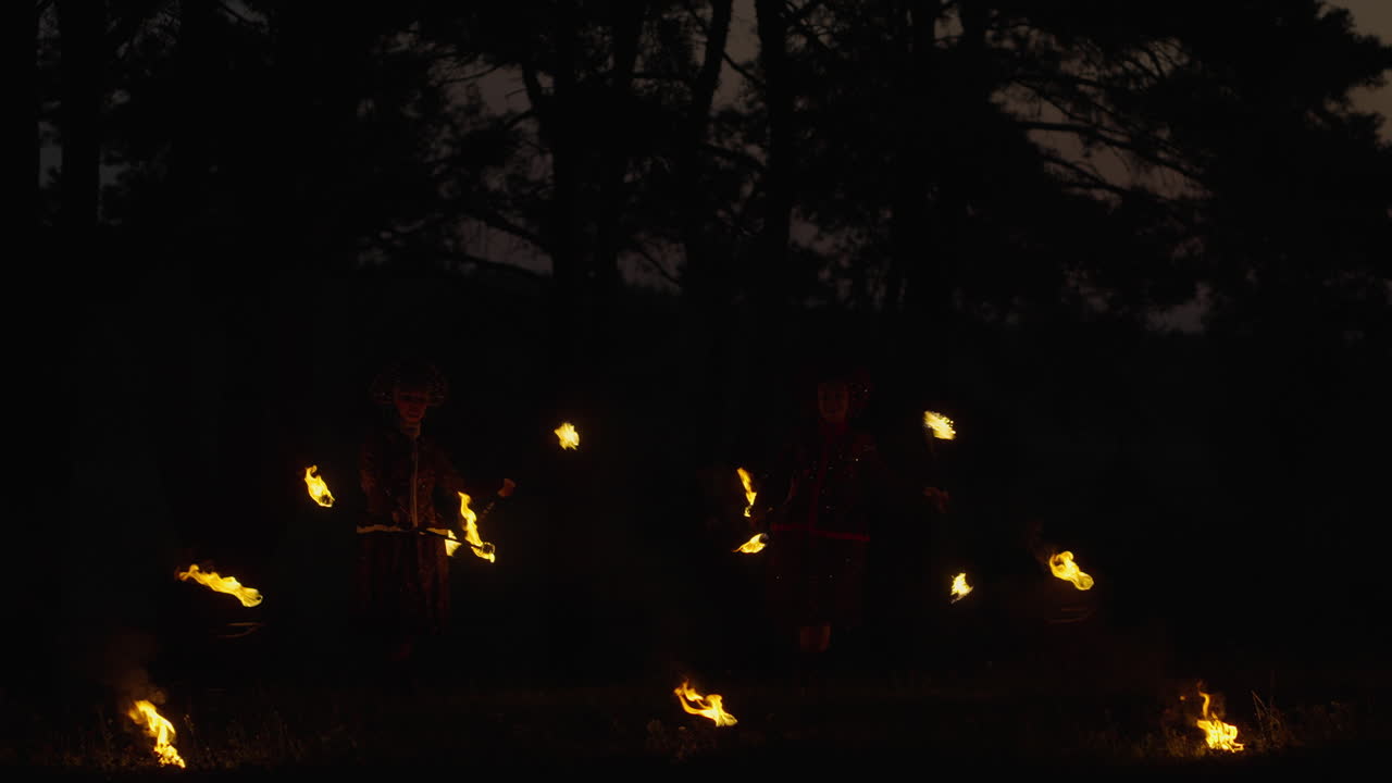 Fire Jugglers in the Woods at Night