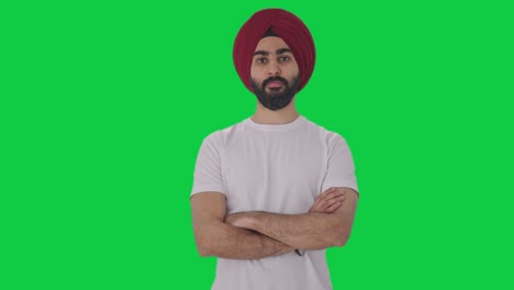 confident sikh indian man standing crossed hands green screen