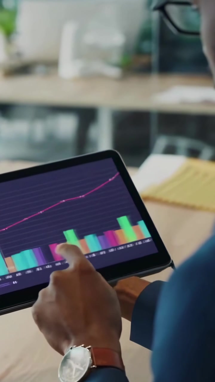 Business Professional Analyzing Financial Data on a Tablet