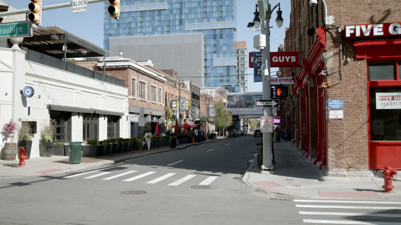 A bustling city street scene with restaurants and businesses