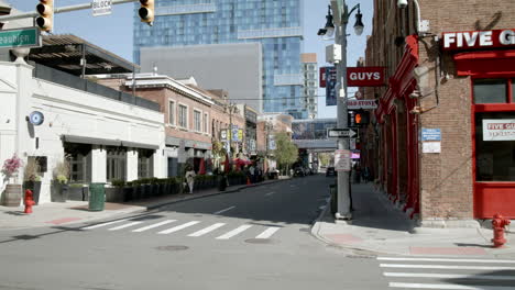 a bustling city street scene with restaurants and businesses