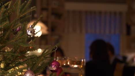 christmas tree, family together at christmas dinner table