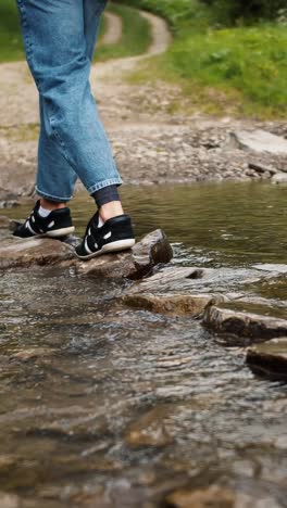 person hiking through a rocky creek
