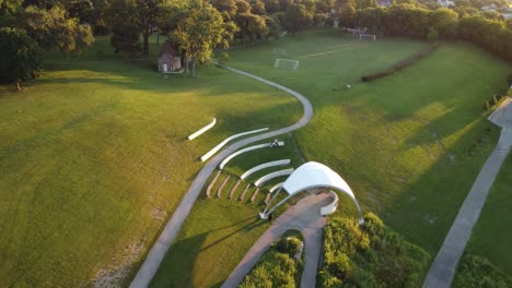 drone push in towards kadish park in milwaukee during a summer sunrise 4k