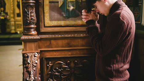 man praying indoors