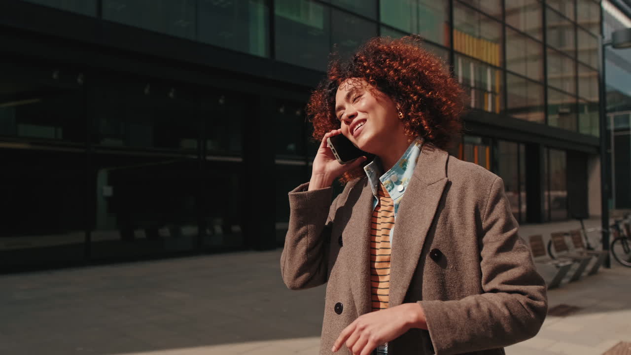 Young Business Woman Walking and Talking on Phone