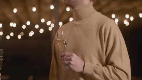 Portrait-Of-Man-Drinking-Champagne-And-Talking-At-New-Year's-Eve-Party