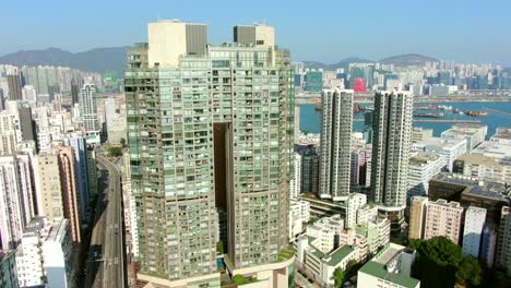 Aerial-shot-of-Downtown-Hong-Kong-mega-residential-skyscrapers-and-traffic,-on-a-beautiful-day